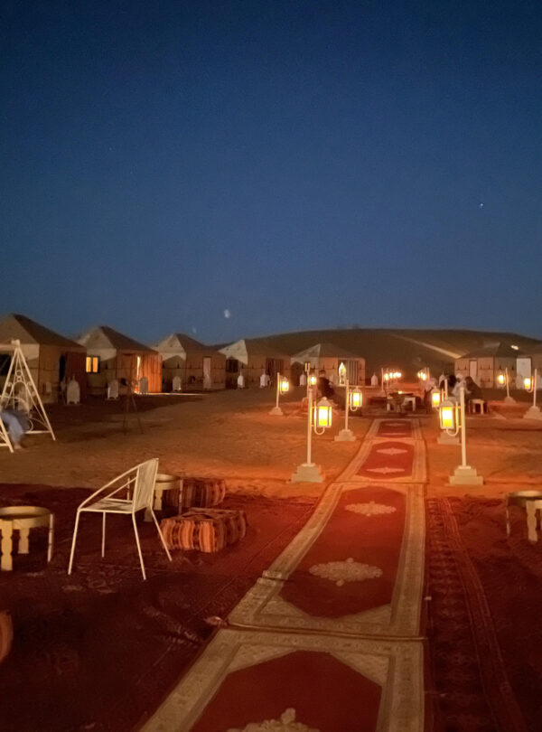 Desert camp surrounded by the golden dunes of Erg Chegaga in Morocco